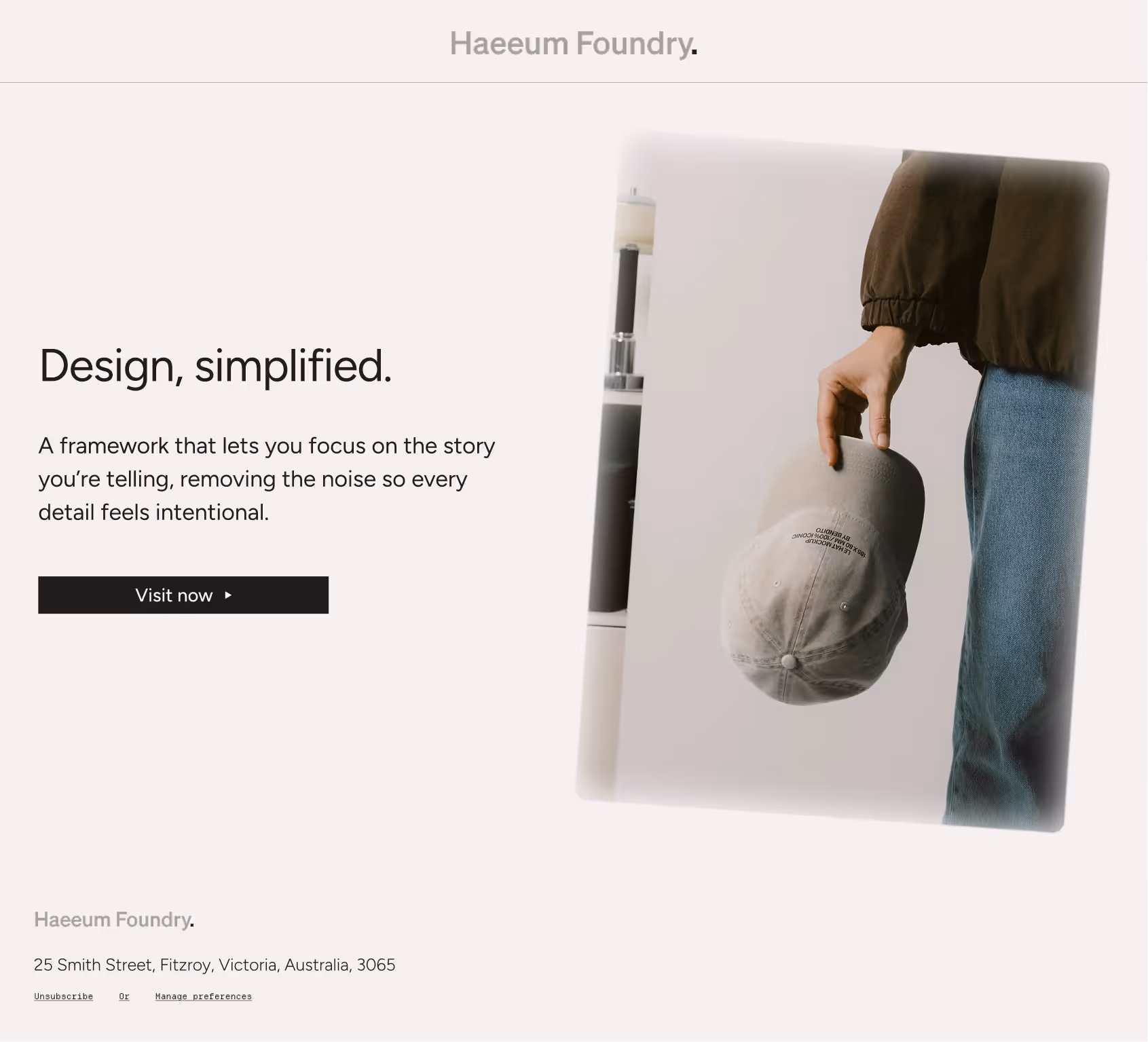 Person holding gray cap by side, next to text about design and a visit button.