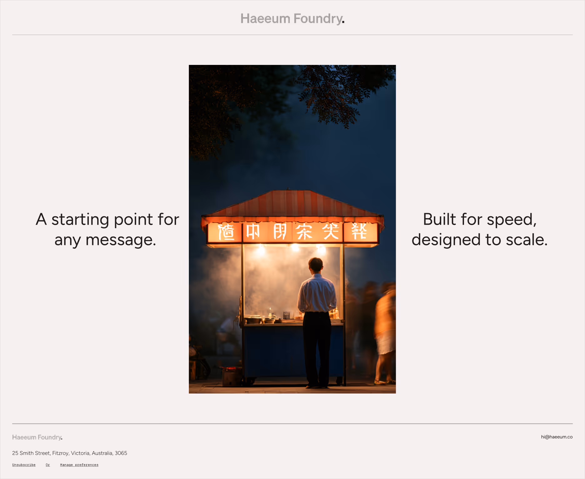 Man standing at a lit street food cart at night with smoke and blurred people around.