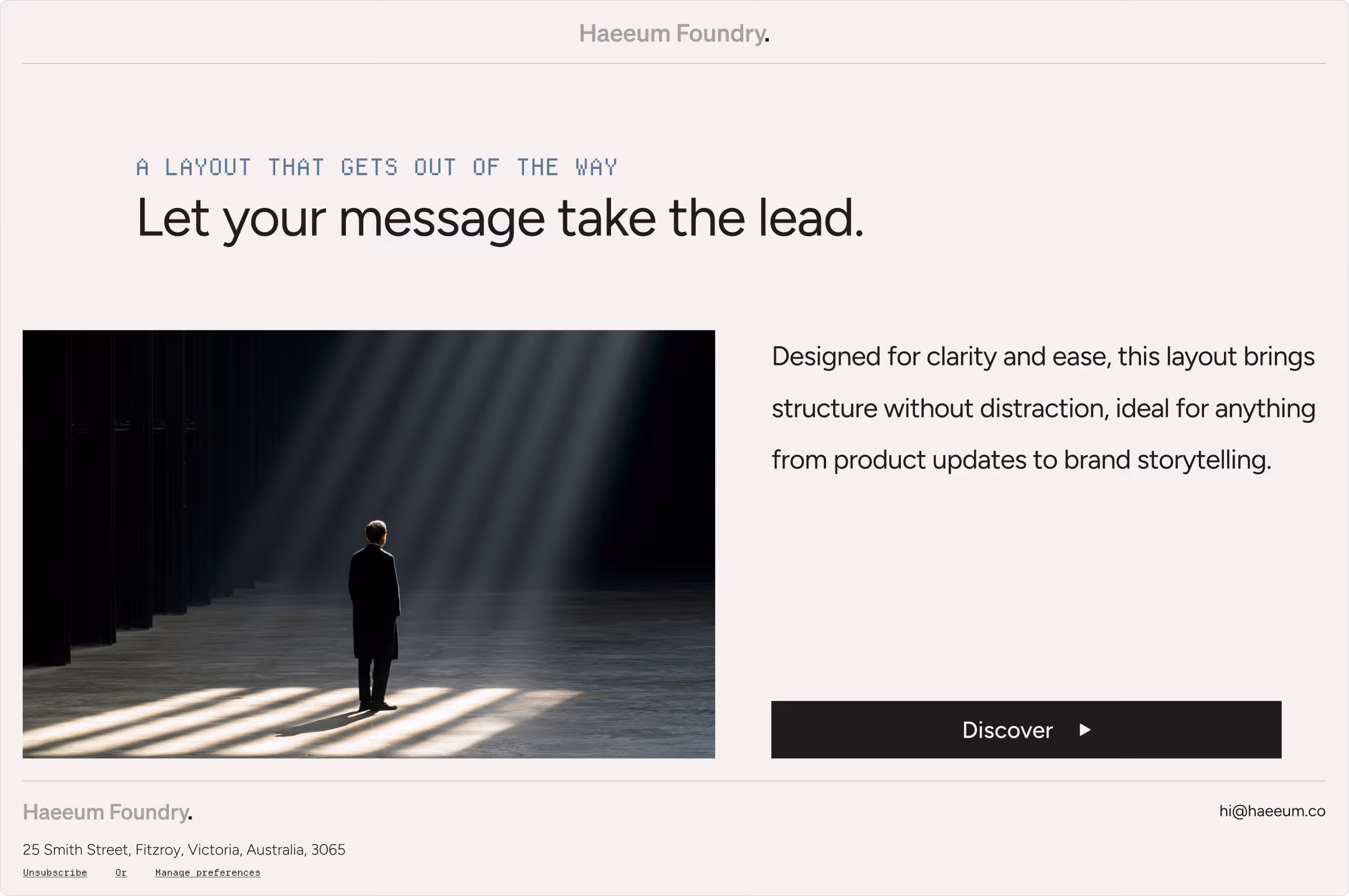 Person standing alone in a dark large space with beams of light streaming down from above.